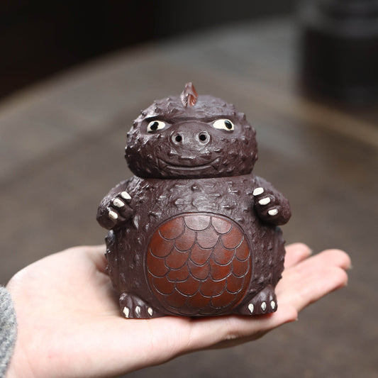 Le pot à main en sable violet de minerai brut de Yixing n'est pas chaud, la théière bionique Godzilla infusant le pot équitable ensemble de thé tasse sculpture en gros